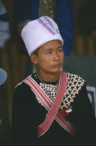Young Lisu man at New Year dance wearing his New Year studded jacket and white towel turban