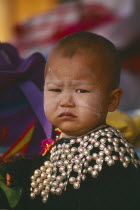 Portrait of a Lisu infant boy wearing New Year silver studded jacket