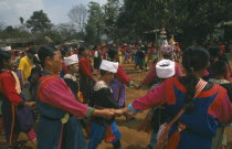 Lisu people dancing around a New Year tree to a banjo player