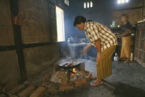 Jinghpaw women cooking food for funeral dinner Burma