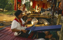 Young Lawa woman weaving on a back strap loom
