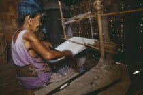 116 year old woman weaving on a back strap loomBurma Myanmar