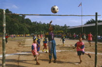 Lisu boys playing soccer in a village school yardFootball