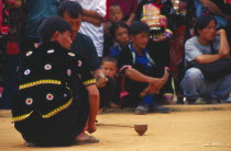Hmong men spinning top at Hmong New Year festival