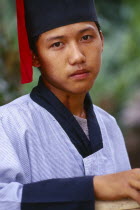 Portrait of a Lisu man with Mahkhong marks on his neck in traditional Lisu attire of the Putao area Burma