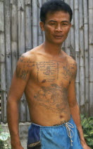 Portrait of a man with tatooed torso and arms