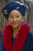 Portrait of a Iu Mien woman in traditional attire at her Village Baan Lao Shi Kuay