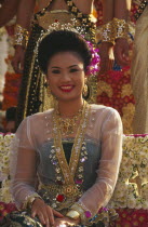 Portrait of young woman riding the beauty contest float in the Flower Festival parade