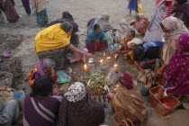 Hindu women worshipping an earthen image of Hindu God Bhim at Asi Ghat