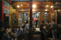 Men chatting outside a shop at night near the chowk