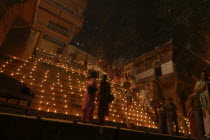 Deep Divali Festival. View looking up steps leading down to the Ganges River with festival goers and oil lamps