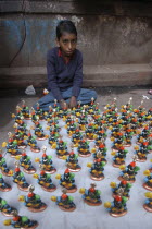 Young boy selling figurines of Kala Bhairava outside Kala Bhairava Temple