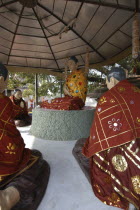 Statues of the Buddha preaching his first sermon in front of the Bodhi tree next to Mulgandha Kuti Vihara.