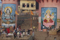Murals of Shiva and Parbati at Dashaswamedh Ghat with Hindu pilgrims on the steps