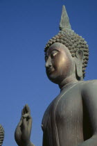 Seema Malakaya on Beira Lake. Angled view looking up at the head and hand of a Buddha statueSimamalaka