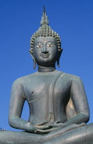 Seema Malakaya on Beira Lake. Seated Buddha statue against a blue skySimamalaka