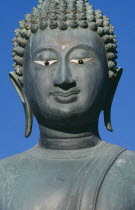 Seema Malakaya on Beira Lake. Face of a Buddha statue against a blue skySimamalaka