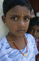 Portrait of a young schoolgirl wearing gold jewellery