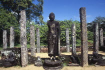 The Atadage. Standing Buddha statue among stone columns within the quadrangle