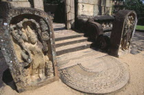 The Hatadage circular relic house. Detail of a guardstone which flanks one of the four entrances of the inner terrace and moonstone leading to the central dagoba