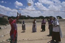 Girls playing volleyball at Fatima Bihi school wearing long skirts and head coverings.