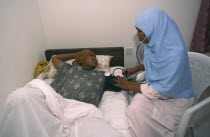 Nurse taking blood pressure of pregnant woman in Edna Adan maternity hospital.