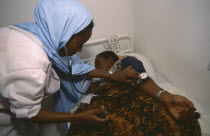 Nurse taking blood pressure of patient in Edna Adan maternity hospital.