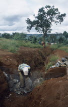 Refugees making gambions from stone filled wire cages to prevent water erosion.Refugees from the Congo and Rwanda fleeing conflict in Burundi Zaire