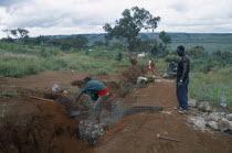 Refugees making gambions to prevent water erosion.  Base of structure is stone filled wire cages covered with earth.Refugees from the Congo and Rwanda fleeing conflict in Burundi Zaire