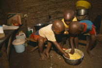 Refugee children eating maize porridge.Refugees from the Congo and Rwanda fleeing conflict in Burundi Zaire