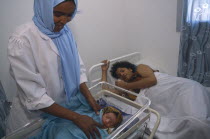Nurse attending mother and new born baby in Edna Adan maternity hospital.