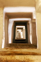 Alleyway through series of rectangular framed doorways. Ghadamis Gadames
