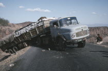 World Food Programme lorry with trailer having slipped off the road