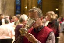 Catholic Parishioner sipping wine from chalice during communi at the Christmas Pageant in the Basilica of St Mary.