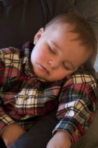 1 year old grandson sound asleep at the family Christmas party.