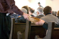 Passing offering basket at church.