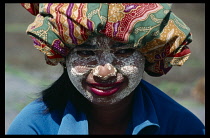 Portrait of girl wearing rice flour on her face as sun protection.