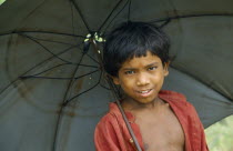 Portrait of schoolboy with an umbrella.