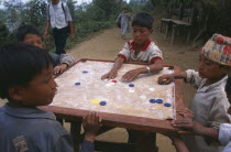 Limbu boys playing karem board game.