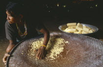 Macuna woman sieving manioc that has previously been grated washed and pressed.