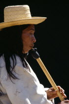 Kogi man playing flute.Kogi flute resembles a huge matchstick