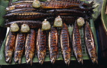 Lam Yai Market.  Stall displaying grilled fish and bags of dipping sauce for sale.Asian Prathet Thai Raja Anachakra Thai Siam Southeast Asia Siamese