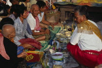Shaman at ceremony smelling the offerings of food brought by the Khmer peopleAsian Cambodian Kampuchea Religion Southeast Asia Kamphuchea Religious