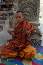 Buddhist monk chanting from Sanskrit prayers inscribed on palm leaf. Asian Cambodian Kampuchea Religion Southeast Asia Kamphuchea Religion Religious Buddhism Buddhists