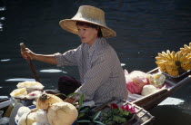 Damnoen Saduak Floating Market female fruit vendors in her canoeAsian Prathet Thai Raja Anachakra Thai Siam Southeast Asia Holidaymakers Siamese Tourism Tourist Sightseeing Tourists