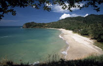 Klong Jark or Waterfall Bay seen through trees with waves rolling ashore