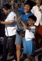 Kuan Yin Teng or Temple of Mercy with young boy releasing a caged bird to earn merit