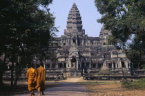 Two monks walking on the east road leading to the rear of the main temple buildingAsian Cambodian Kampuchea Religion Southeast Asia 2 History Kamphuchea Religious