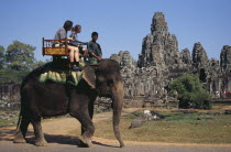 Bayon Temple south facade with tourists on an elephant walking pastAsian Cambodian Kampuchea Religion Southeast Asia Holidaymakers Kamphuchea Religious Tourism