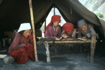 Kirghiz children taking lessons inside yurt. Ger